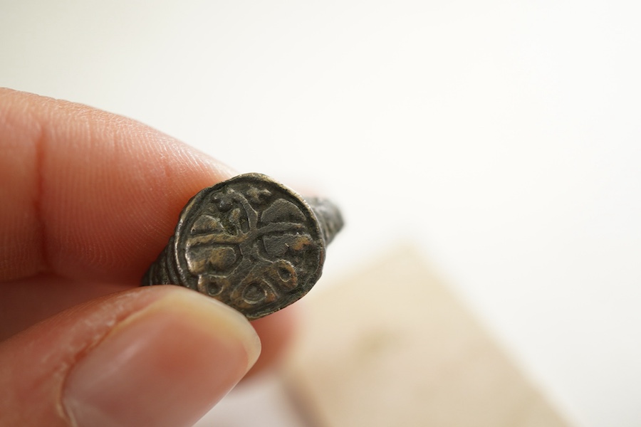 A sentimental signet ring, France, circa 16th century, the circular panel depicting two hearts tied in a true lover's knot, size R1/2, labelled 2244, Provenance: formerly in the collection of Dame Joan Evans (1893-1977)